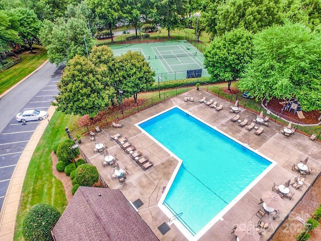 view of swimming pool with tennis court