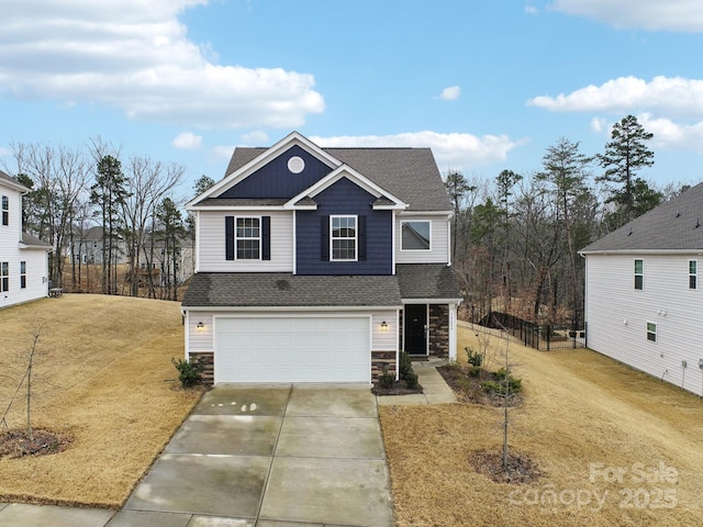 view of front of home with a front yard and a garage