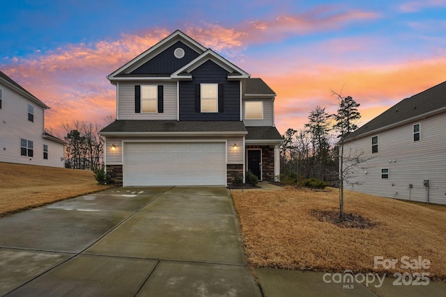 view of front property with a yard and a garage