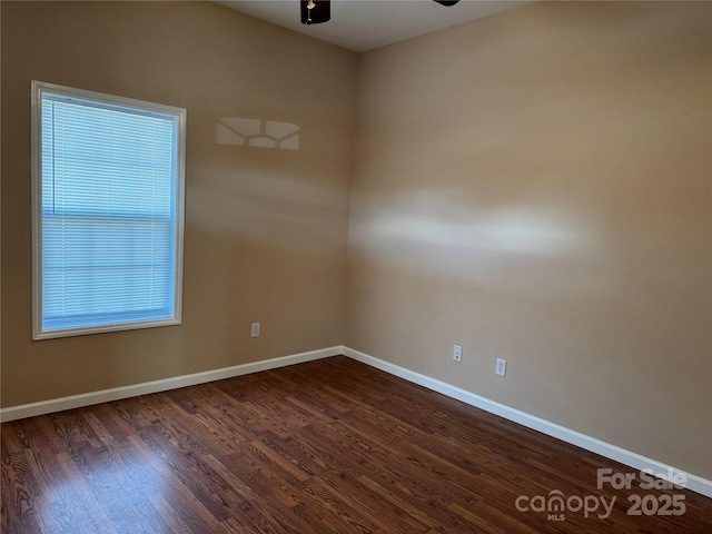 unfurnished room featuring ceiling fan and dark hardwood / wood-style floors