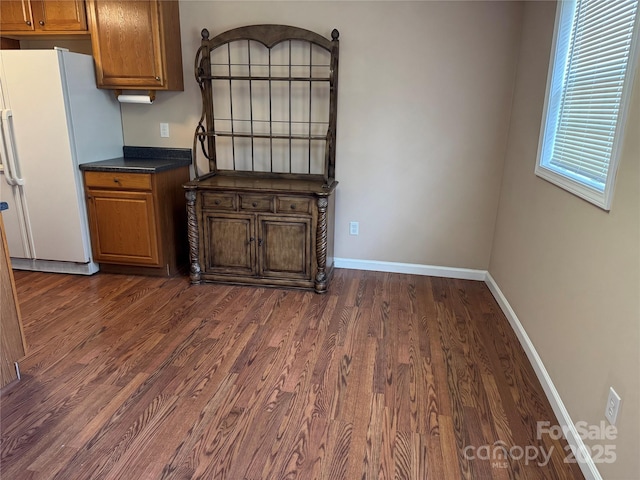 kitchen featuring dark hardwood / wood-style flooring and white fridge