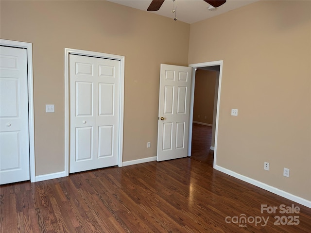 unfurnished bedroom featuring ceiling fan and dark wood-type flooring