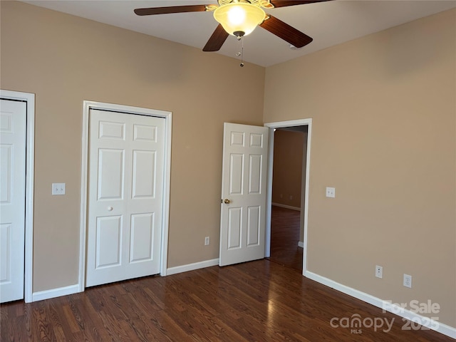 unfurnished bedroom featuring ceiling fan and dark hardwood / wood-style floors