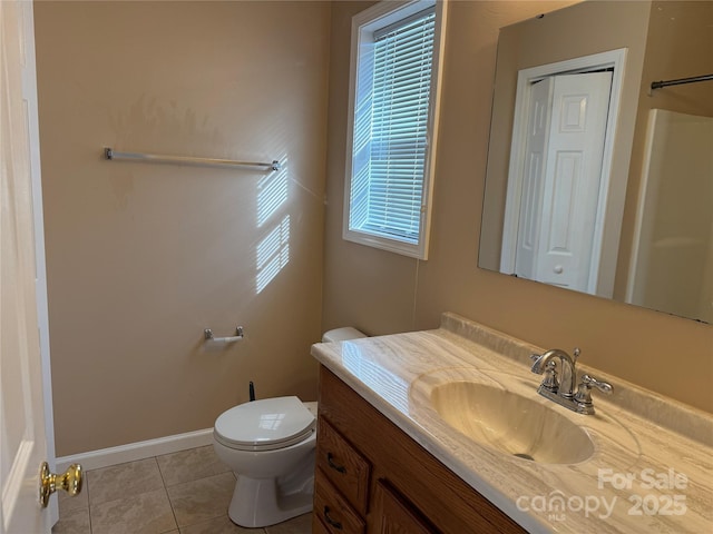 bathroom featuring tile patterned floors, vanity, and toilet