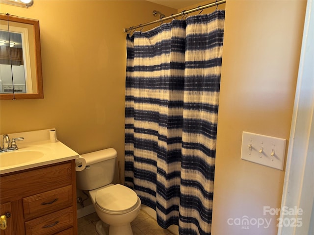 bathroom featuring toilet, vanity, tile patterned floors, and walk in shower