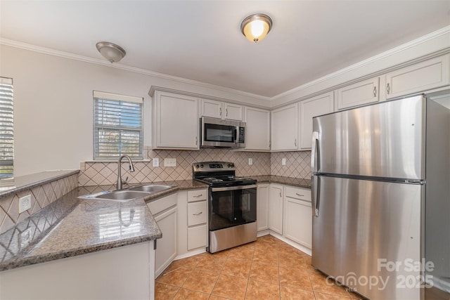 kitchen with stainless steel appliances, light tile patterned floors, backsplash, dark stone counters, and sink