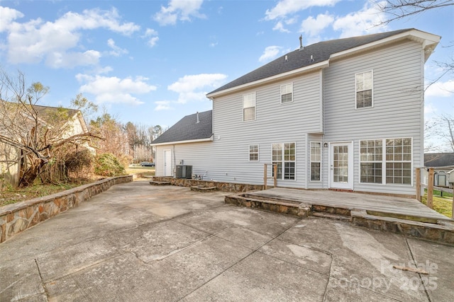 rear view of house with a patio, central AC unit, and a deck