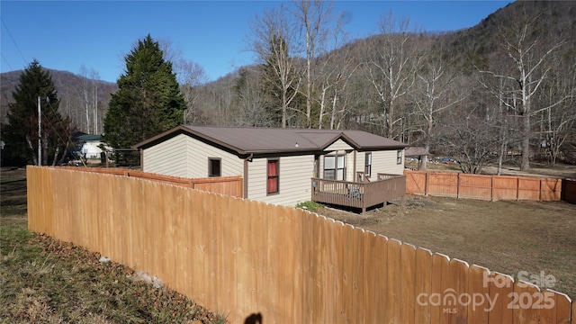 back of house featuring a deck with mountain view