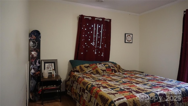 bedroom featuring hardwood / wood-style floors and crown molding