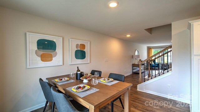 dining area featuring dark wood-type flooring, stairway, baseboards, and recessed lighting