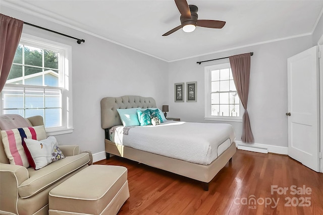 bedroom featuring multiple windows, ceiling fan, crown molding, and wood-type flooring