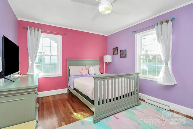 bedroom featuring wood-type flooring, ceiling fan, and ornamental molding