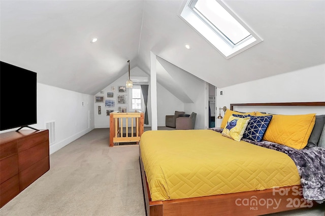 carpeted bedroom featuring vaulted ceiling with skylight