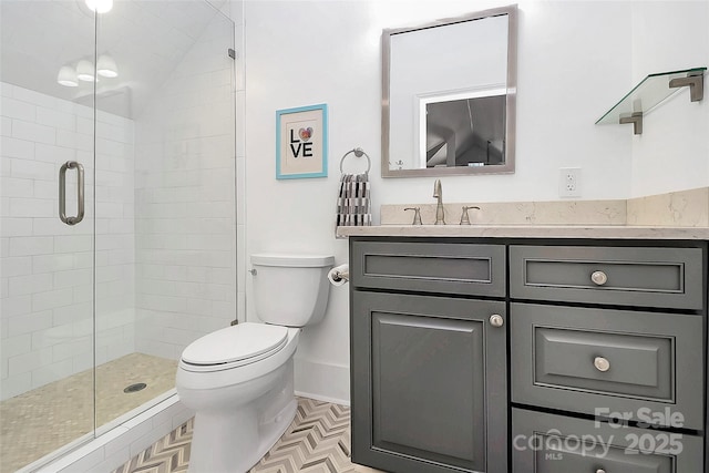 bathroom with vanity, toilet, and a shower with door