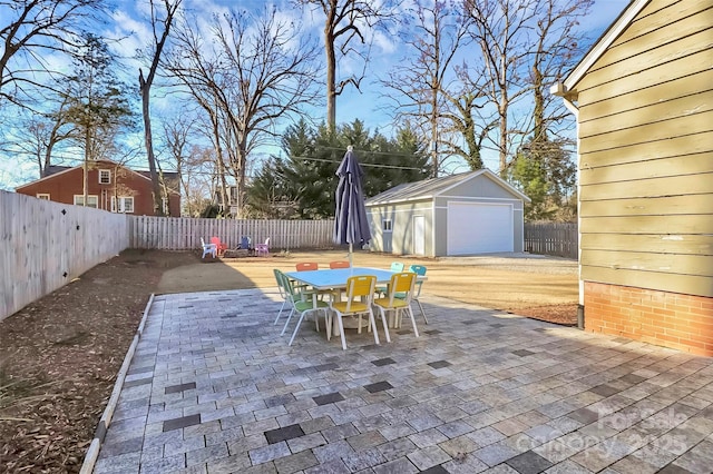 view of patio with an outbuilding and a garage