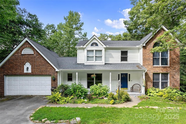 view of front property featuring a garage and covered porch