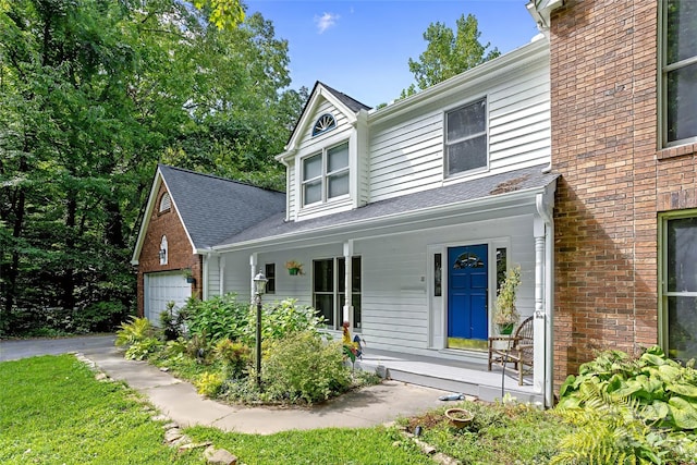 view of front of home featuring a porch and a garage