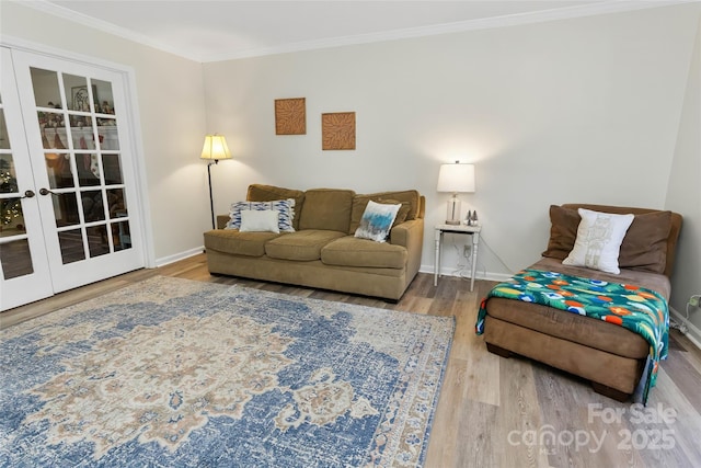 living room with hardwood / wood-style floors, ornamental molding, and french doors