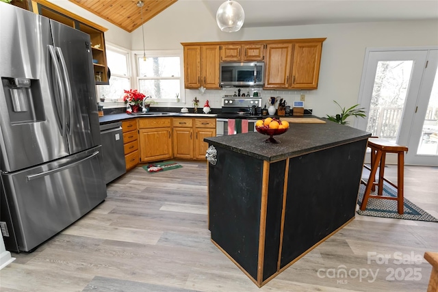 kitchen with backsplash, a wealth of natural light, wooden ceiling, and appliances with stainless steel finishes