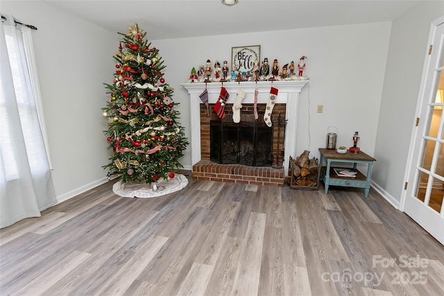 living room with light wood-type flooring and a fireplace