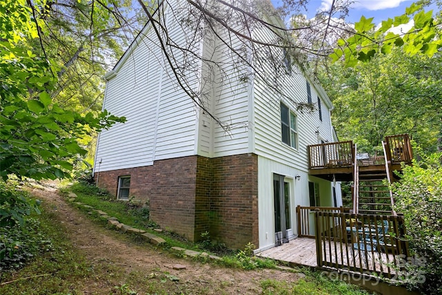 view of side of home featuring a wooden deck