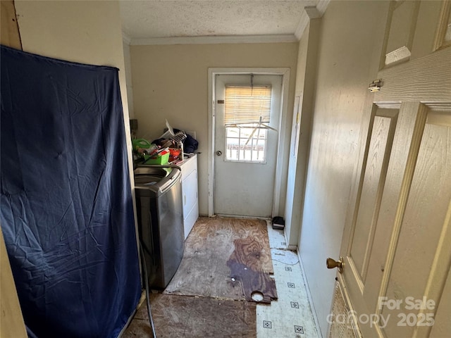 laundry room with washer and dryer, ornamental molding, and a textured ceiling