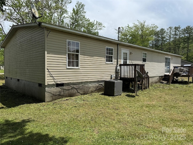 back of house with a lawn, crawl space, central AC, and a wooden deck