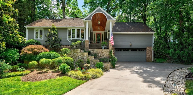 view of front facade with a garage, concrete driveway, and brick siding