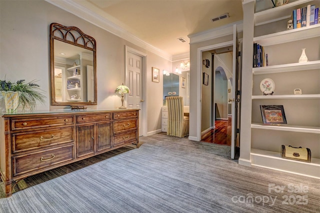 bathroom with built in features, vanity, and ornamental molding