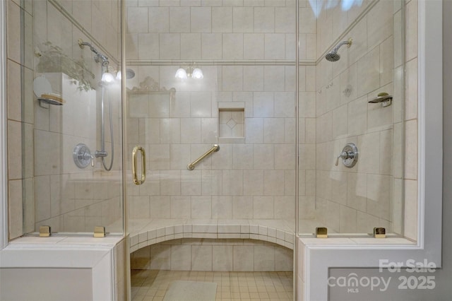 bathroom featuring a shower with door