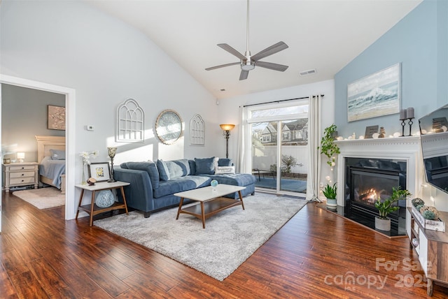 living room with ceiling fan, dark hardwood / wood-style floors, and high vaulted ceiling