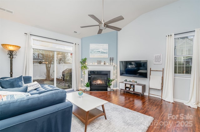 living room featuring lofted ceiling, dark hardwood / wood-style floors, and ceiling fan