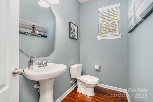 bathroom with wood-type flooring and toilet