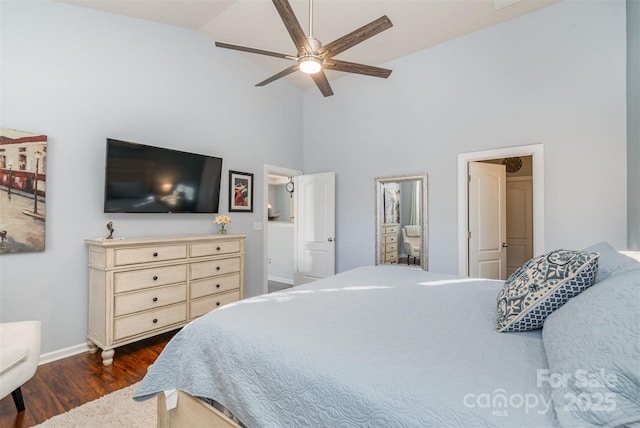 bedroom with ceiling fan, dark hardwood / wood-style floors, and high vaulted ceiling