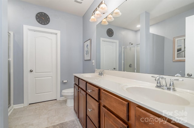 bathroom featuring vanity, toilet, and an enclosed shower