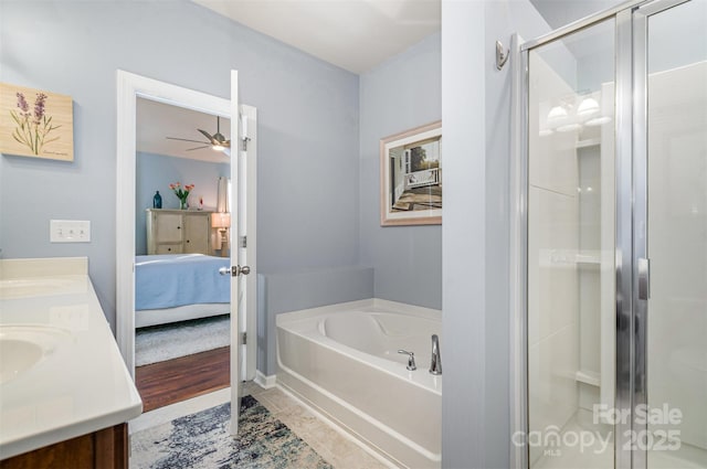 bathroom with ceiling fan, tile patterned floors, separate shower and tub, and vanity