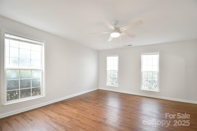 spare room with ceiling fan and wood-type flooring