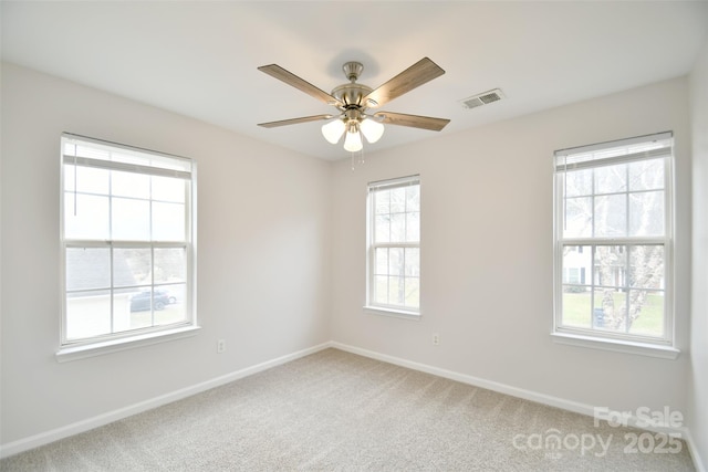 empty room featuring carpet, visible vents, ceiling fan, and baseboards