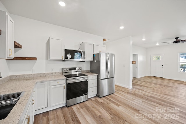 kitchen featuring light stone countertops, ceiling fan, white cabinets, and stainless steel appliances