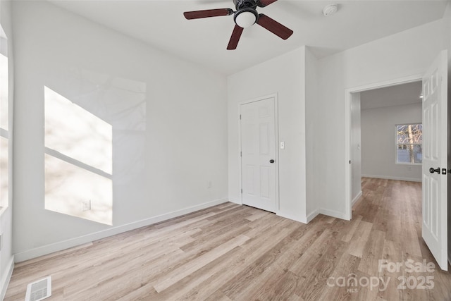 unfurnished bedroom featuring ceiling fan, light wood-type flooring, and a closet