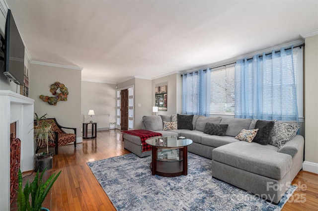 living room with plenty of natural light, ornamental molding, and hardwood / wood-style flooring