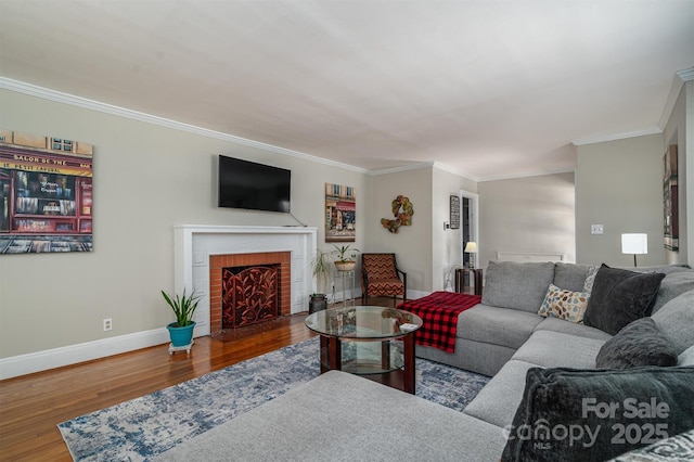 living room featuring a brick fireplace, ornamental molding, and hardwood / wood-style flooring