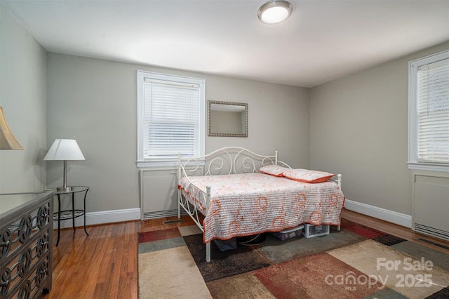 bedroom with dark wood-type flooring