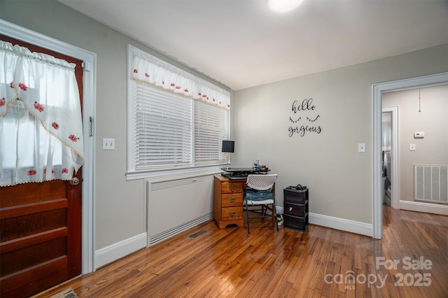 home office with hardwood / wood-style flooring