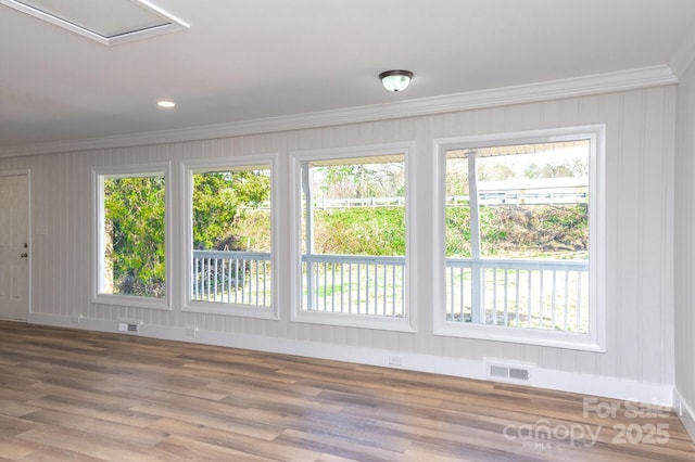 spare room with ornamental molding and wood-type flooring