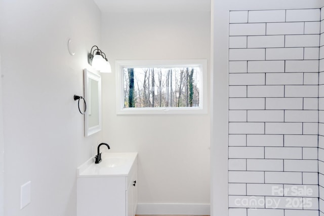 bathroom featuring vanity and a tile shower