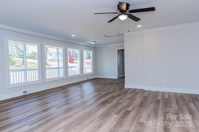 empty room featuring crown molding, ceiling fan, and light wood-type flooring