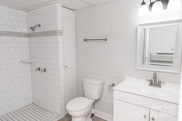 bathroom featuring vanity, tiled shower, cooling unit, and toilet