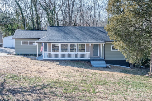 single story home with covered porch and a front lawn