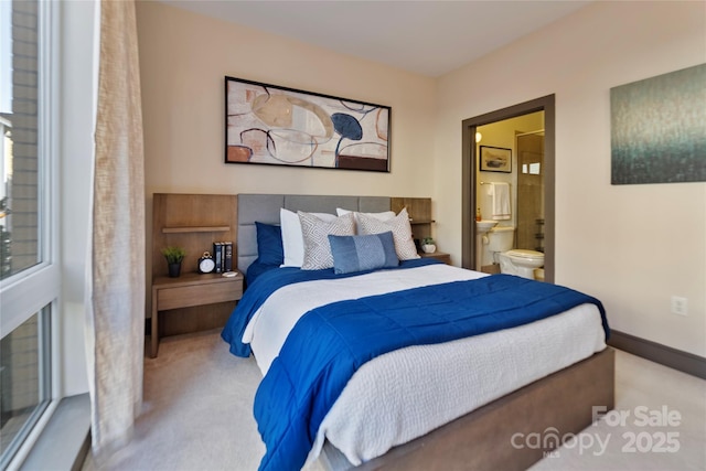 carpeted bedroom featuring ensuite bathroom